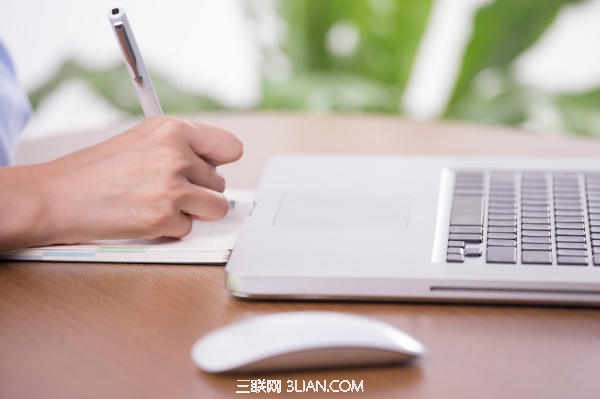 Businesswoman clicking the mouse and writing documents